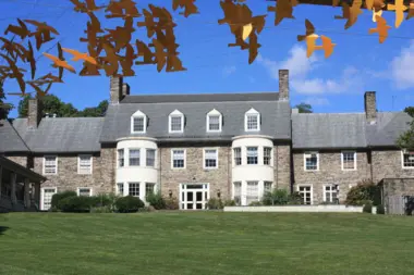 A stone building and lawn in Abington Township.